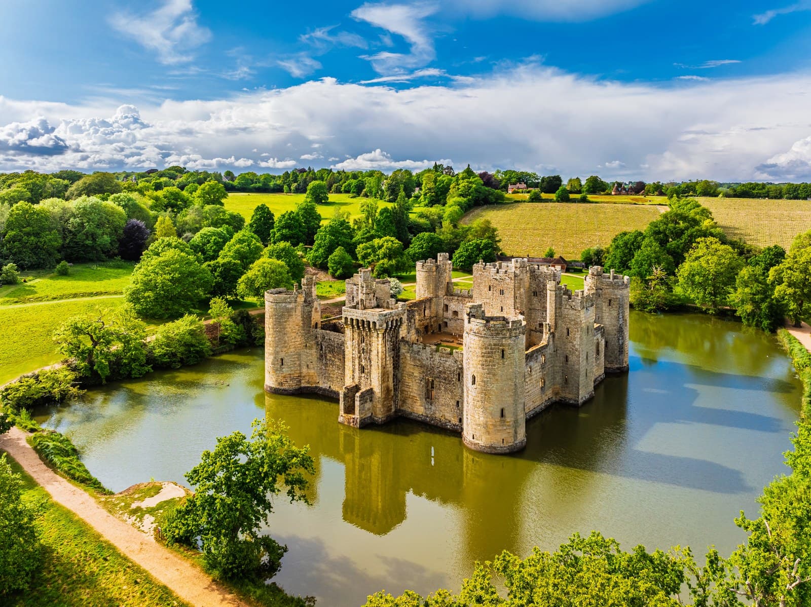 Bodiam Castle standing in its wide rectangular moat, seen from the air above the Rother valley
