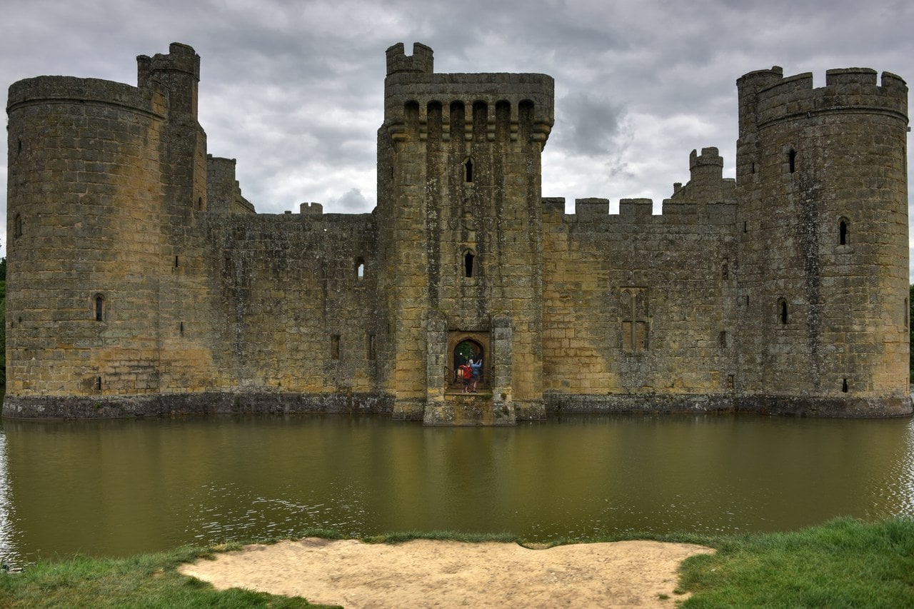 South front of Bodiam Castle across the moat, a square central tower between two round corner towers