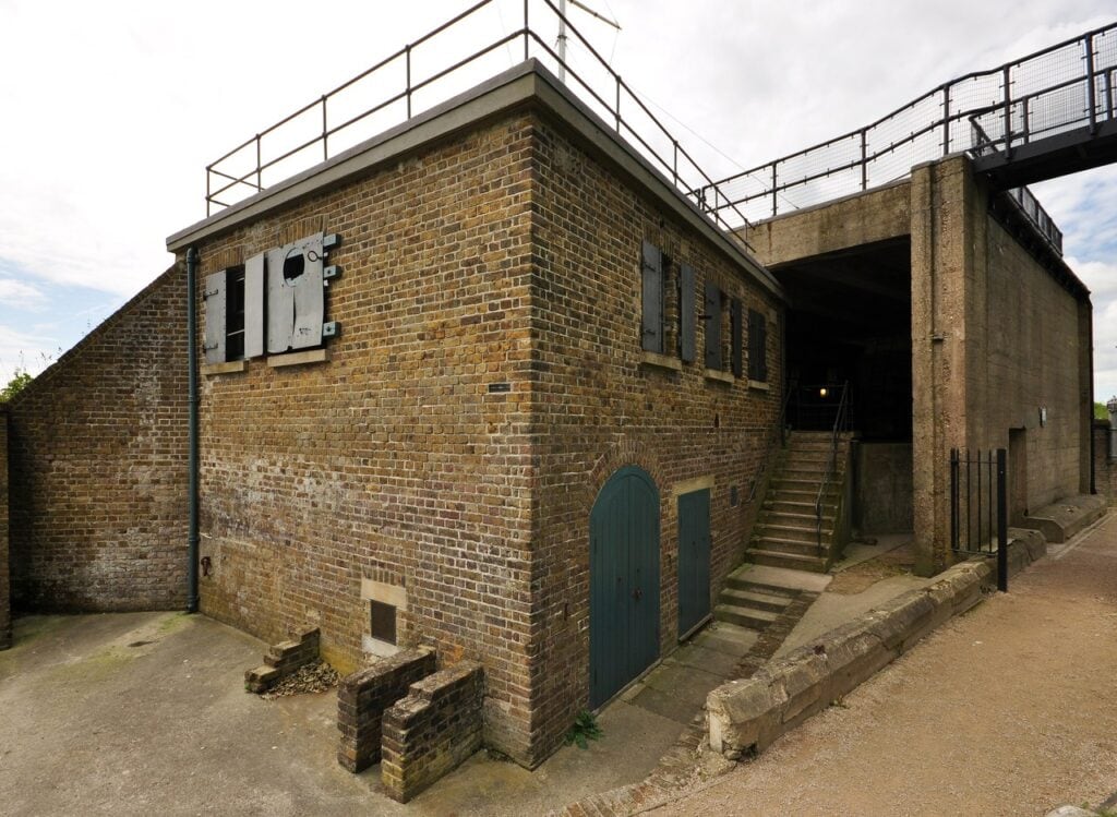 Dover Castle 10 A brick observation post with shuttered window openings and a railed walkway across its flat roof.