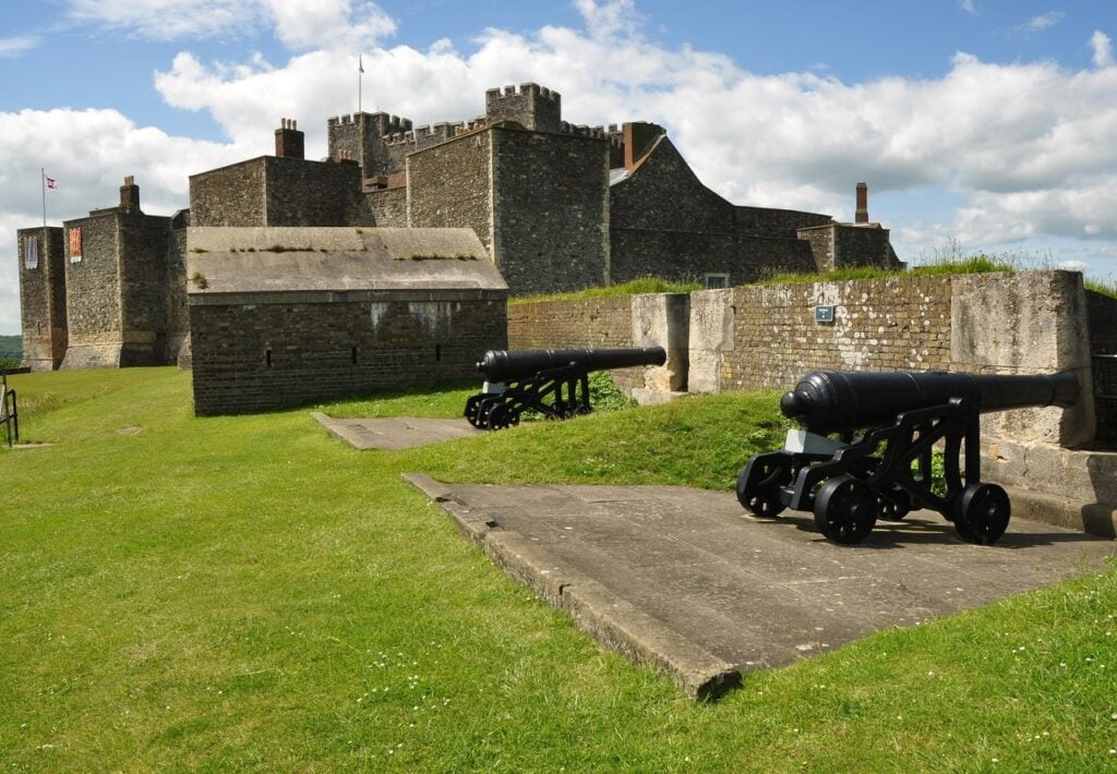Dover Castle 6 Two cannon on wooden garrison carriages standing on concrete platforms in front of the inner bailey wall and the Great Tower.