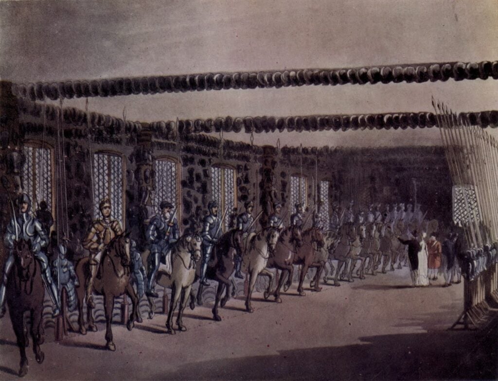 A hand-colored aquatint of a long hall with rows of armored figures on horseback, weapons arranged on the walls and ceiling, and visitors at right.
