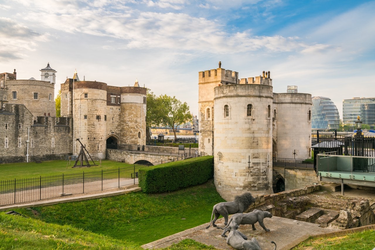 The western entrance: the round white stone towers of the Middle Tower at right and, beyond a bridge over the grassed moat, the twin towers of the Byward Tower.