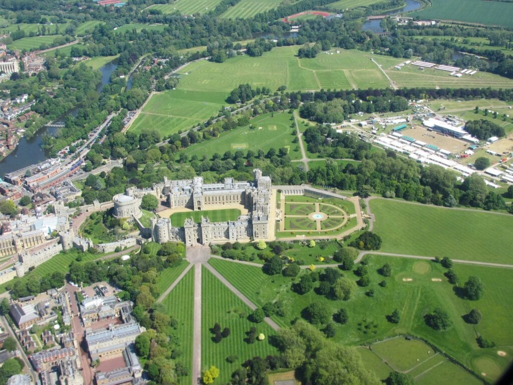 Windsor Castle 2 Oblique aerial view of Windsor Castle on its ridge, the town crowding one side and a long straight avenue running away across parkland on the other