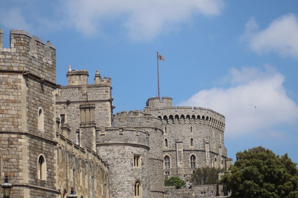 Windsor Castle 10 The Round Tower with a flag flying, seen behind the drum towers and ranges below it against a blue sky