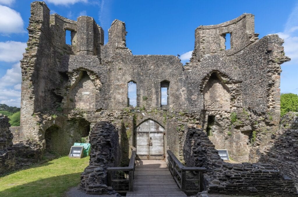 Caerphilly Castle 4 A roofless two-towered stone gatehouse ruin with window openings high in its walls and a timber walkway leading to a wooden door